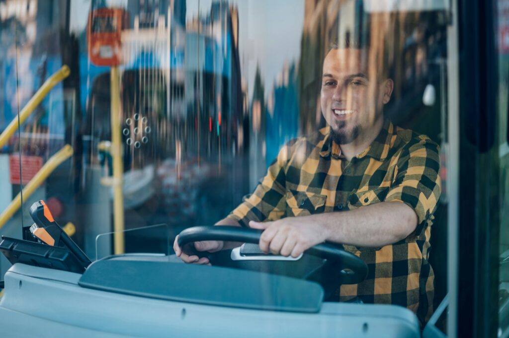 Bus driver behind the wheel of a public transport vehicle